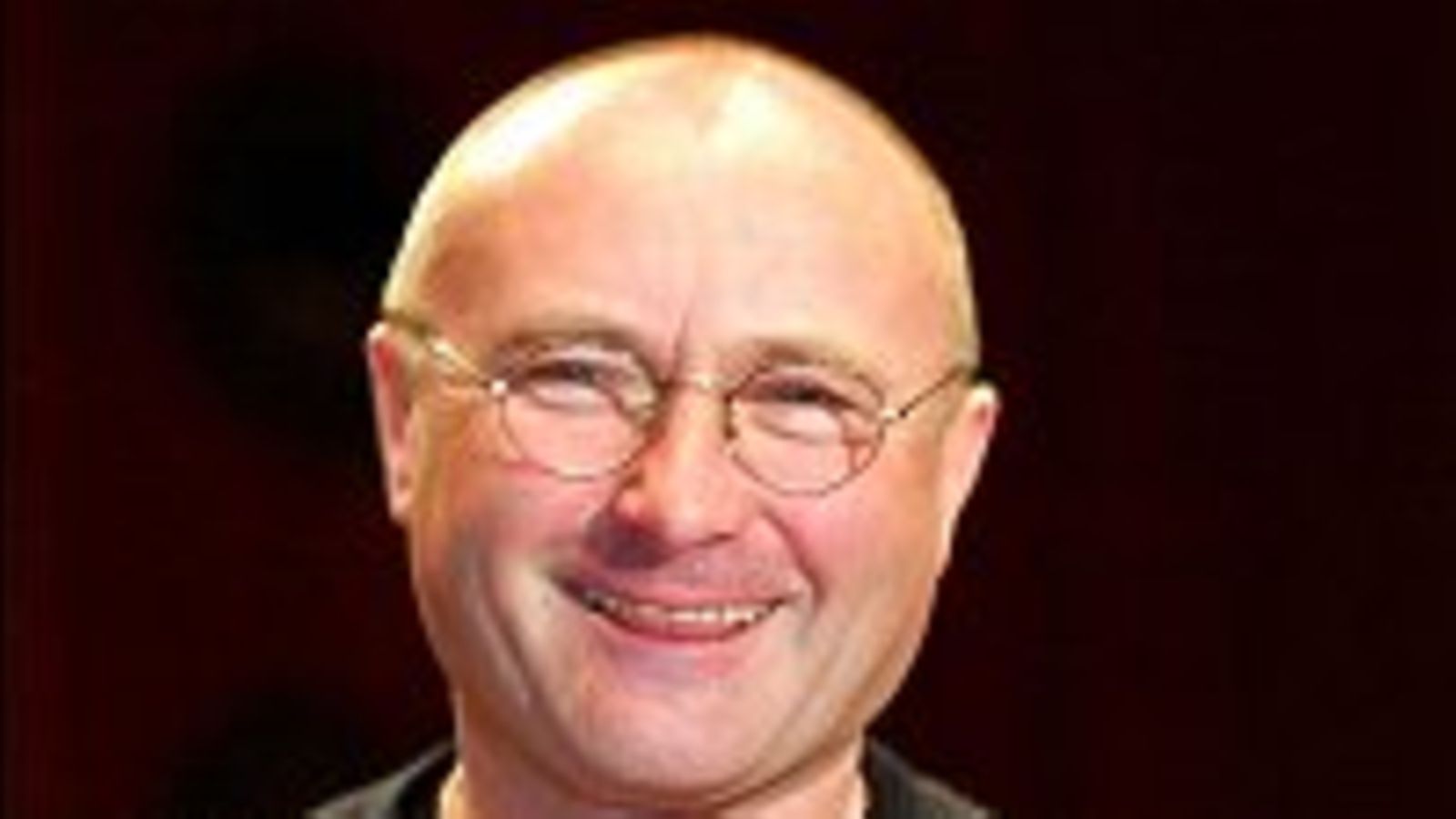 Phil Collins hymyilee lähikuvassa, huhti 2003