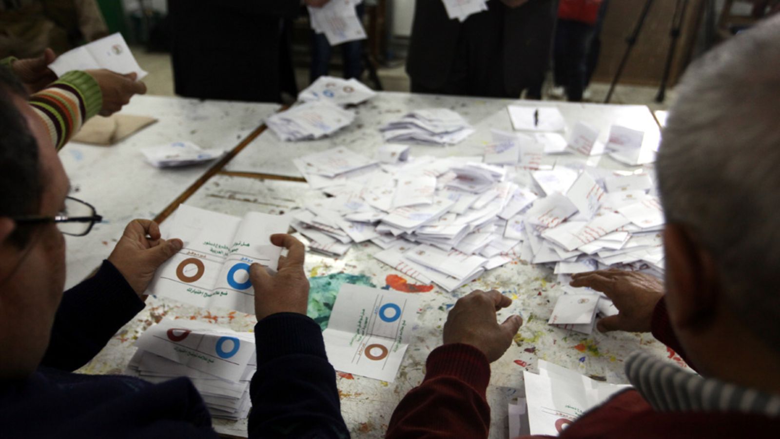 Egyptian election officials count ballots after voting in the second round of a referendum for the new Egyptian constitution, at a polling station in Giza, Egypt, 22 December 2012. More than 25 million eligible Egyptians were called to cast their ballots 22 December in the final phase of a referendum on a disputed draft constitution that has sparked demonstrations by pro- and anti-government protesters. Voting was taking place in 17 electoral districts that are considered to be broadly conservative, meaning a yes vote is expected to prevail.