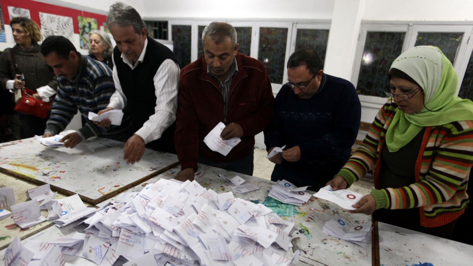 Egyptian election officials count ballots after voting in the second round of a referendum for the new Egyptian constitution, at a polling station in Giza, Egypt, 22 December 2012. More than 25 million eligible Egyptians were called to cast their ballots 22 December in the final phase of a referendum on a disputed draft constitution that has sparked demonstrations by pro- and anti-government protesters. Voting was taking place in 17 electoral districts that are considered to be broadly conservative, meaning a yes vote is expected to prevail.