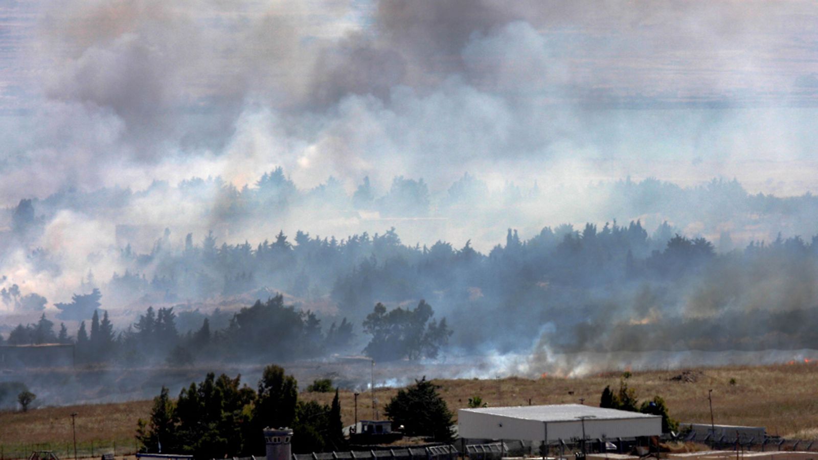 Smoke caused by shelling rises on the Syrian side of the border, next to the Israeli-Syrian border crossing of Quneitra, in the Golan Heights, Israel, 06 June 2013.