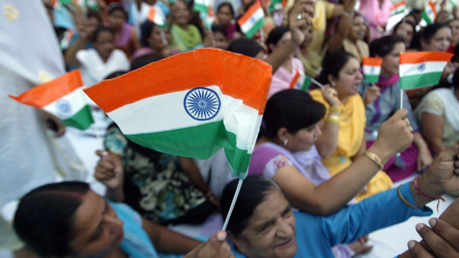Women activists of Bhartiya Janta Party (BJP) hold Indian flags as they take part in a protest against the Indian government and in support of social activist, Anna Hazare after his arrest in New Delhi, in the northern Indian city of Amritsar, 16 August 2011.