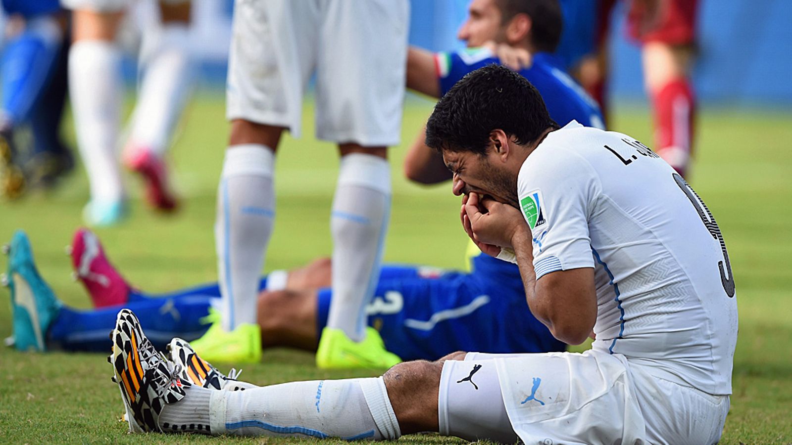 Luis Suarez piteli hampaitaan, Giorgio Chiellini (takana) olkapäätään